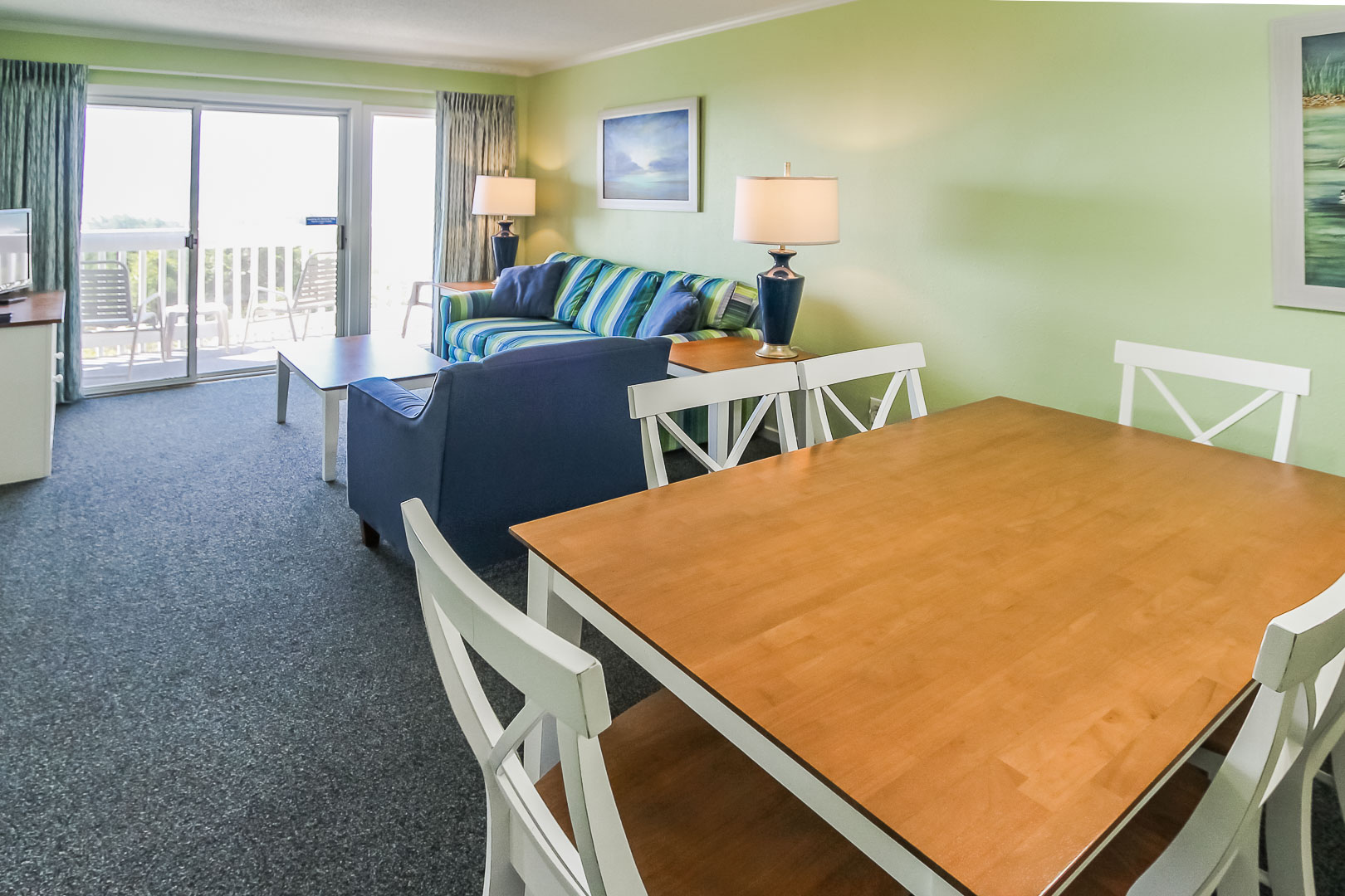 A colorful living area and dining room at VRI's A Place at the Beach III in North Carolina
